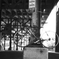 Custom aluminum frame with a flat black powder coat. Phil Wood hubs of course. Used it for messengering in Cleveland. It’s got a ton of battle scars from over the years and still one of my favorite bikes.