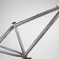 Titanium 29er MTB hardtail with rack and fender mounts for touring.