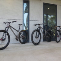 All three of his bikes. A titanium gravel road and two MTB’s. One MTB is a double butted titanium 27.5″ and the other is straight gauge 26″.