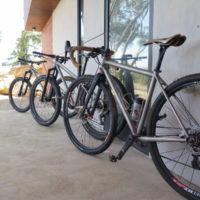 All three of his bikes. A titanium gravel road and two MTB’s. One MTB is a double butted titanium 27.5″ and the other is straight gauge 26″.