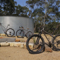 All three of his bikes. A titanium gravel road and two MTB’s. One MTB is a double butted titanium 27.5″ and the other is straight gauge 26″.